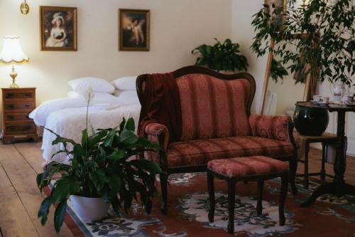a bedroom with a couch and a chair and a bed at Anija mõis in Anija