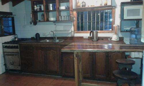 a kitchen with a wooden counter top and a sink at Complejo Rancho Grande in Nueva Atlantis