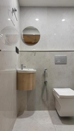 a bathroom with a sink and a toilet at The Zen Retreat in Kozhikode