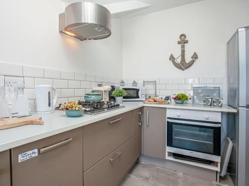 a kitchen with a sink and a stove top oven at Mamhead View in Exmouth