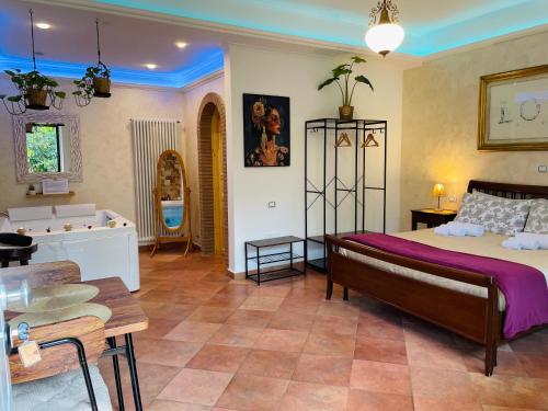 a bedroom with a bed and a tub in a room at Room24 Relax & Wellness in Genzano di Roma
