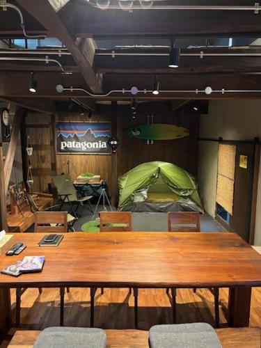 a wooden table and chairs in a room with a tent at いとしま風遊 in Itoshima
