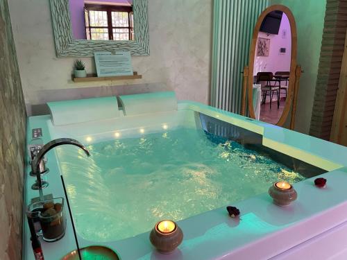 a bath tub filled with water in a bathroom at Room24 Relax & Wellness in Genzano di Roma