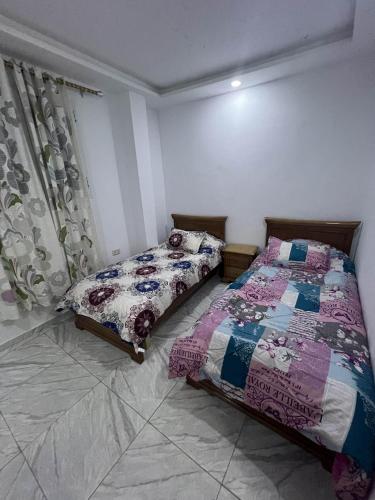 a bedroom with two beds in a room at Assef home in Midoun