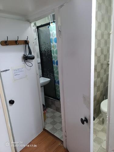 a bathroom with a toilet and a sink at Tsogoo Guesthouse Shared rooms in Ulaanbaatar
