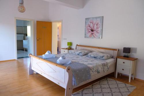a bedroom with a bed with a wooden frame at Villa Vinko in Donje Raštane
