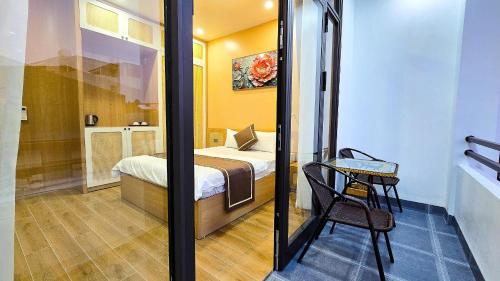 a small bedroom with a bed and a table and a chair at Ha Anh Villa Ninh Binh in Ninh Binh