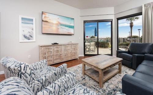 a living room with two couches and a tv at Phoenix VI 6004 in Orange Beach