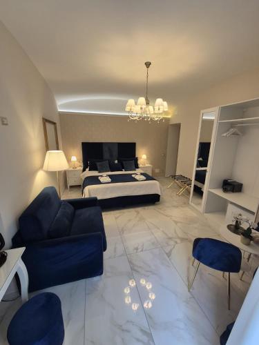 a large bedroom with a bed and a blue couch at Napoli Sogno Infinito in Naples