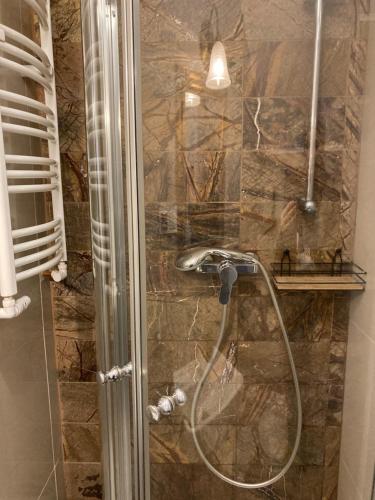 a shower with a shower head in a bathroom at Ciao Italia in Gdynia