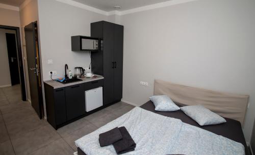 a small bedroom with a bed and a kitchen at Mia Mia House in Katowice