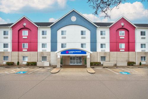 a large building with red and blue paint on it at Candlewood Suites Conway by IHG in Conway