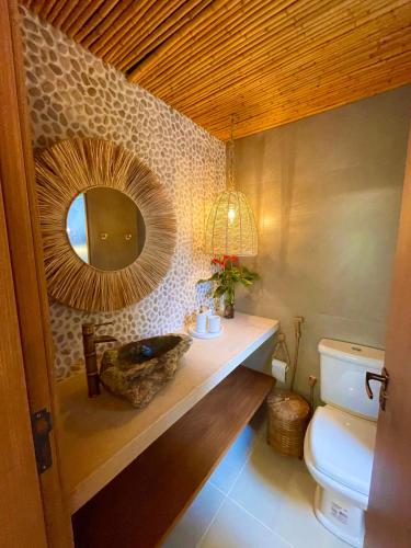 a bathroom with a sink and a mirror on the wall at Chalé Mar e Sol, Marina e Resort Angra in Angra dos Reis