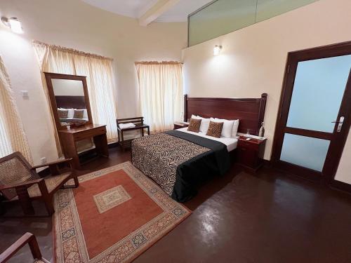 a hotel room with a bed and a mirror at The Deane Residence Double Room in Colombo