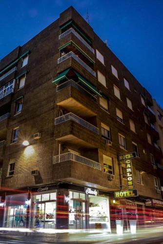a building on the corner of a street at night at Hotel Carlos III in Águilas