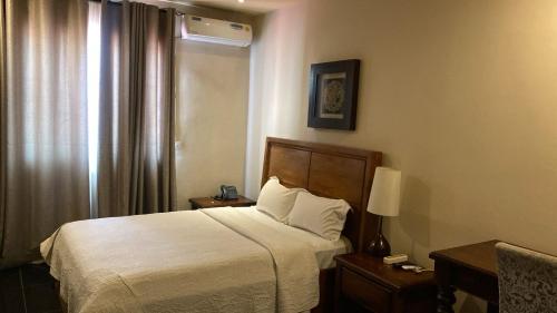 Llit o llits en una habitació de Bella Casa Hotel