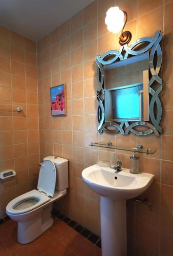 a bathroom with a toilet and a sink and a mirror at Trivista Khaoyai in Ban Khanong Phra Klang (1)