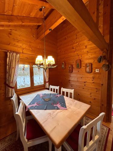 a dining room with a wooden table and chairs at Blockhaus Bayerischer Wald in Stamsried