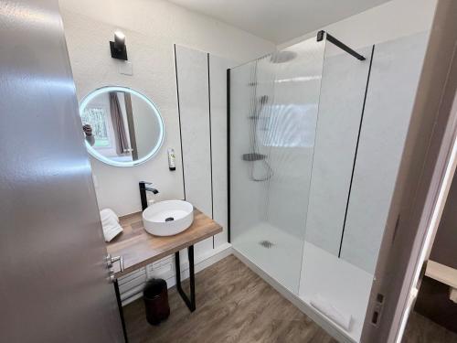 a bathroom with a sink and a shower at Hotel ARBOR - Les Hunaudieres - Le Mans Sud - Mulsanne in Mulsanne