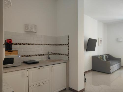 a kitchen with a sink and a microwave at CconfortHotels Sea Dream Palace in Trani