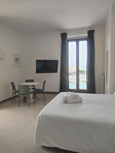 a bedroom with a bed and a table with chairs at CconfortHotels Sea Dream Palace in Trani