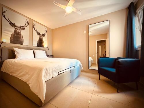 a bedroom with a bed with two deer heads on the wall at Valparaíso Apartments Flamingo in San Bartolomé