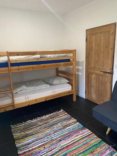 a room with two bunk beds with a rug at Chez Rachel in Mérélessart