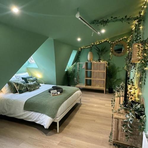 a bedroom with a large bed with christmas lights at Jungle Suite - Sauna et Relaxation in Arras