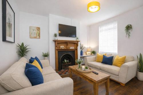 a living room with two couches and a fireplace at Falklands street City centre House-Free Parking in York