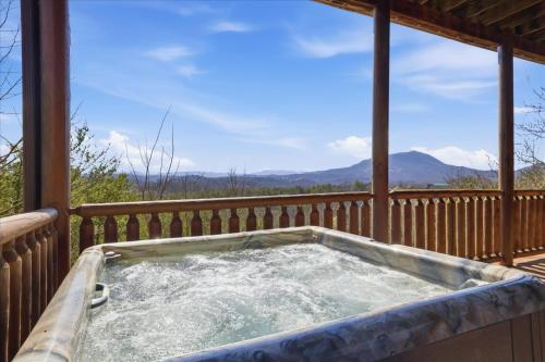 a hot tub on the deck of a cabin at Smoky Mountain Bliss by Beyond Expectations in Sevierville