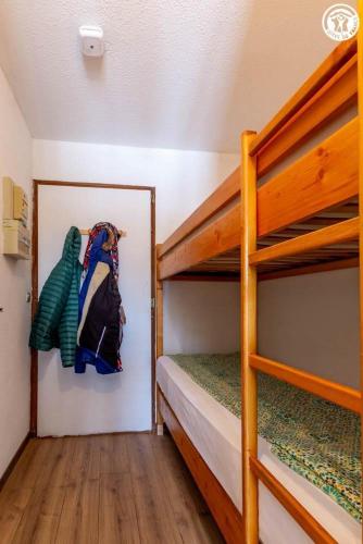 a bedroom with two bunk beds and a picture on the wall at Dans les mélèzes in Saint-Pancrace