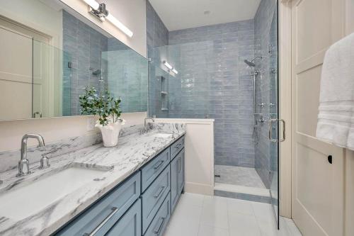 a bathroom with a large sink and a shower at Seafarer Lodge South in Jekyll Island
