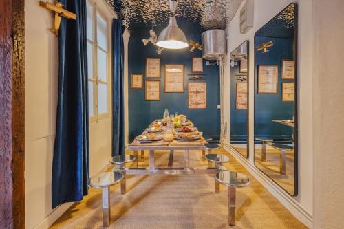 a table with food on it in a room with blue walls at La Planète 612 - Vue Capitole in Toulouse