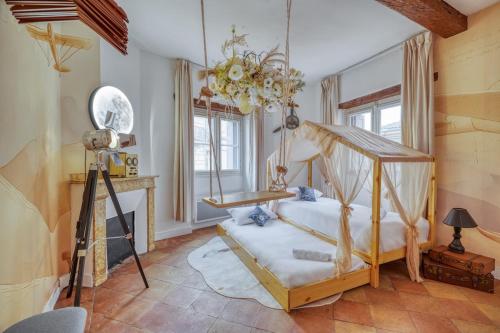 a bedroom with a canopy bed and a fireplace at La Planète 612 - Vue Capitole in Toulouse