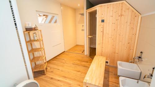 a bathroom with a wooden door and a wooden table at Erasmus 1901 Apartments in Trassem