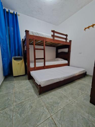 a bedroom with two bunk beds and a trash can at La Tribuna Lounge in Valledupar