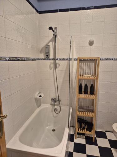 a bath tub in a bathroom with a shower at Escuelas de collía D AT-1537-AS in Arriondas