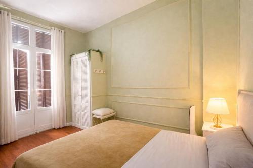 a bedroom with a bed and a window at Apartamentos Málaga centro in Málaga