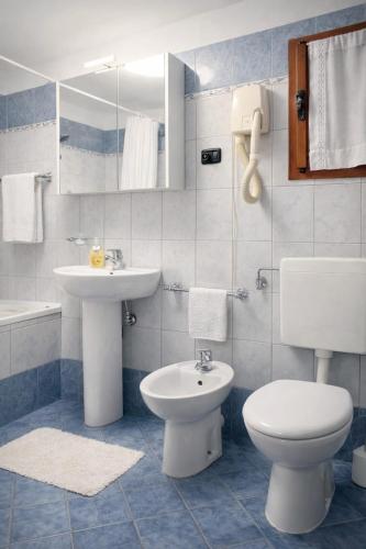 a bathroom with a white toilet and a sink at Jolie Maison in Châtillon