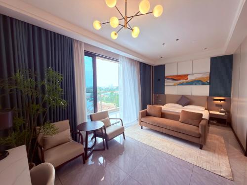 a living room with a couch and a bed and a table at Hotel Eden - 24 Novembre in Kinshasa