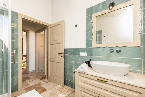 a bathroom with a sink and a mirror at Agorà Apartments in Villasimius