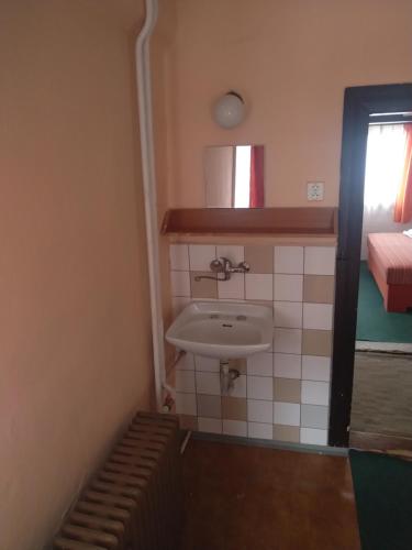 a small bathroom with a sink in a room at Chata Jablunka, Dog friendly, 50m ski slope, 50m restaurant in Pec pod Sněžkou