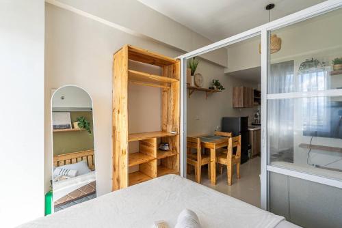 a small room with a bed and a table at Cozy and Nature-Inspired Studio Unit in Agus