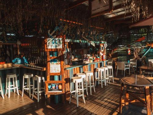 a bar with chairs and tables in a restaurant at Beach Island Graskop in Graskop