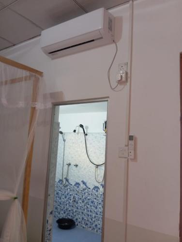 a room with a shower and a door with a window at Dream Haven Mirissa in Mirissa
