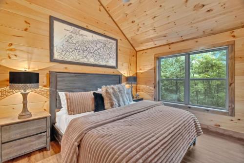 a bedroom with a bed and a couch and a window at Sneaky Bear in Sevierville
