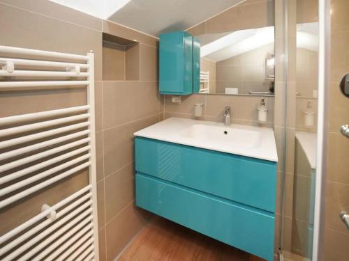 a bathroom with a sink and a blue cabinet at Parco Hermitage - Villa Azalea in Porto Valtravaglia