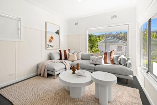 a white living room with a couch and a table at Garrys After Dunes Delight in Norah