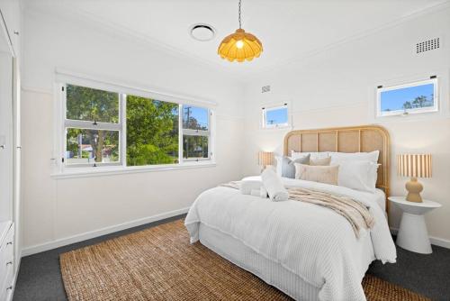 a white bedroom with a bed and a window at Garrys After Dunes Delight in Norah