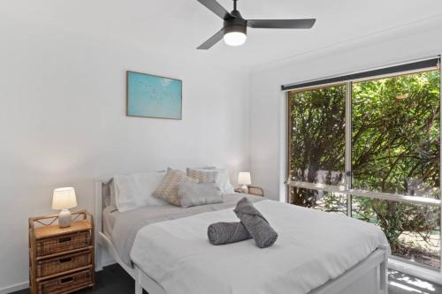 a bedroom with a bed and a large window at Play and Pool Bonnells Bay in Bonnells Bay